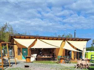 a large tent in front of a building at Apartmán na detskej zážitkovej farme Fajnovô in Nová Baňa