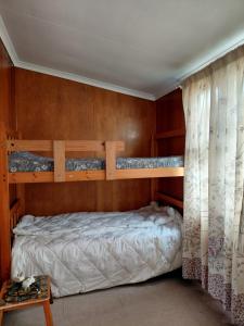 a bedroom with two bunk beds in it at Die Dam Chalet in Pearly Beach
