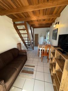 a living room with a couch and a tv and a table at Residencial Solar del Nieto in Garopaba +31 photos