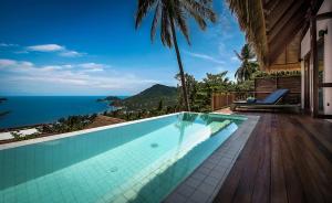 a swimming pool with a view of the ocean at Phandara Luxury Pool Villas in Ko Tao