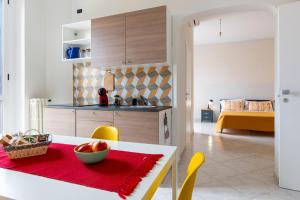 a kitchen with a table with a bowl of fruit on it at Civico 23 in Matera