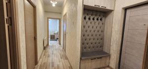 a hallway with a walk in closet and a door at Zara premium apartment 66 in Stantsiya Kyzyl-Tukumachi +17 photos