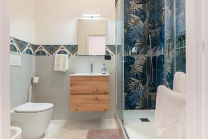 a bathroom with a toilet and a sink and a shower at Civico 23 in Matera +15 photos