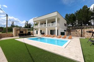 a villa with a swimming pool and a house at Villa Vallis with pool in Kruševo