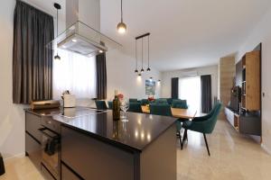 a kitchen and living room with a table and chairs at Villa Vallis with pool in Kruševo