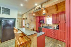 a kitchen with red cabinets and a counter top at Rustic Hollister Cabin - 5 Mi to Downtown Branson in Hollister