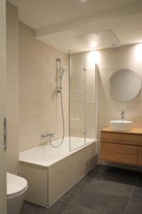 a bathroom with a shower and a tub and a sink at Domaine de Pech Peyrat in Floressas