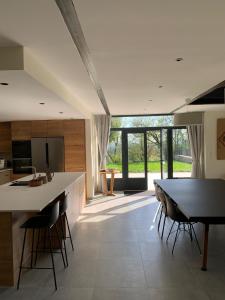 a kitchen and dining room with a table and chairs at Domaine de Pech Peyrat in Floressas