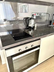 a kitchen with a stove with a tea kettle on it at Luxurious 1 bedroom duplex apartment in Palmera Resort in Ayios Yeoryios +24 photos