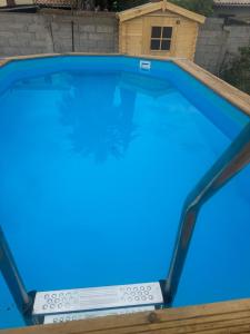 a swimming pool with blue water in a backyard at Villa Maeva Florensac in Florensac