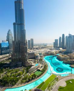 a view of a city with a river and skyscrapers at GRANDE RESIDENCES with a direct Burj Khalifa view and Private Fountain Show at 42nd floor with DXB AIRPORT VIP Shuttle in Dubai