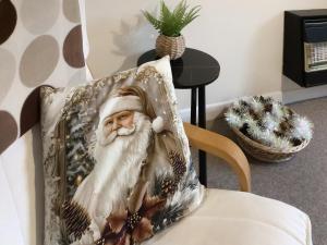 a picture of santa claus on a pillow on a chair at Rosings in Bradfield
