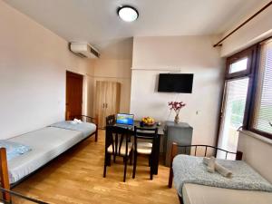 a room with two beds and a desk with a computer at Helena Hostels in Kostinbrod