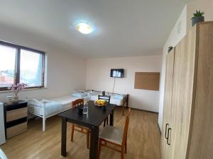 a living room with a table and a couch at Helena Hostels in Kostinbrod