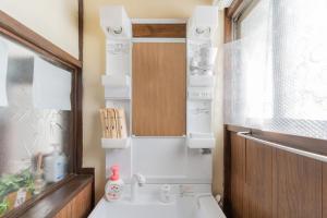 a small bathroom with a sink and a mirror at 日本の生活を体験できる古民家 一棟貸切最大7名 jr上中里駅 in Tokyo +33 photos