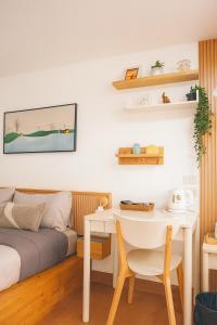 a bedroom with a bed and a table and a desk at Homeku Guesthouse Room 3 Cozy Stay Close to Suvarnabhumi Airport in Lat Krabang