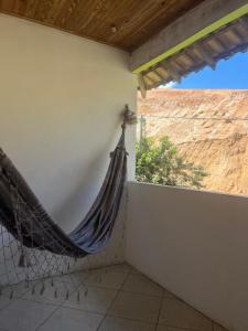 a hammock hanging from a wall in a room at Casa no sana in Macaé +3 photos