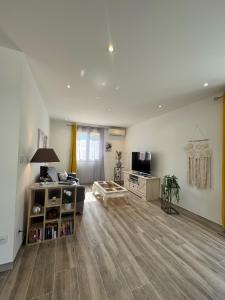a large living room with a couch and a tv at Villa Maeva Florensac in Florensac