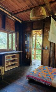a bedroom with a bed and a table in a room at House in the Trees in Ilha de Boipeba +19 photos