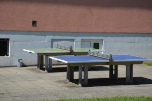 two ping pong tables in front of a building at Kolpinghaus Spittal in Spittal an der Drau
