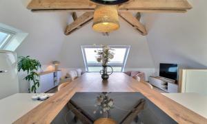 a dining room with a table and a tv at Santec, T3 duplex, face à la mer in Santec
