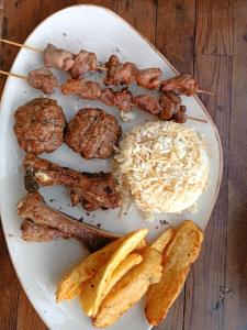 a plate of food with meat and vegetables on a table at Karpaz farm guest house in Iskele +38 photos