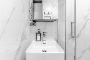a bathroom with a white sink and a mirror at The RRoom in Milan