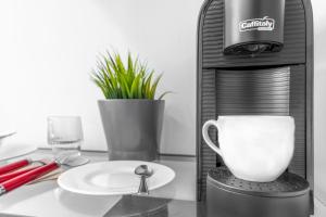 a coffee maker and a cup on a table at The RRoom in Milan
