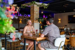 a man and a woman sitting at a table in a restaurant at Recreatiepark 't Gelloo in Ede +18 photos