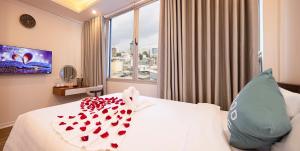 a hotel room with a bed with red hearts on it at SCAT Hotel- New World Bến Thành in Ho Chi Minh City