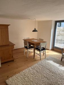 a dining room with a wooden table and chairs at Rufus' Bergblick in Bernau am Chiemsee +8 photos