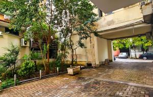 a building with a parking garage with trees in it at Tirana Heart Lodge in Tirana
