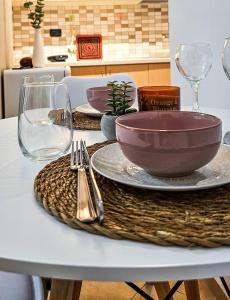 a table with a bowl and wine glasses on it at Tirana Heart Lodge in Tirana