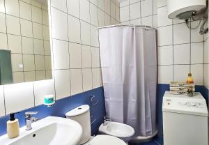 a bathroom with a toilet and a sink and a shower at Tirana Heart Lodge in Tirana +21 photos