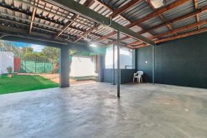 an empty garage with a table and a chair in it at Private Garden Cottage with Kitchenette in Johannesburg +1 photo