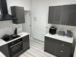 a kitchen with a stove and a counter top at Not Open in Llwyn-y-pia +8 photos