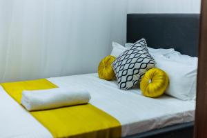 a bed with two pumpkins on top of it at Rustic Paradise Apartments in Kisumu