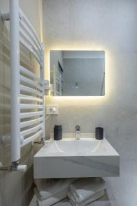 a bathroom with a white sink and a mirror at AER Apart & Wine in Eforie +39 photos