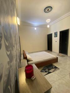 a room with a bed in the middle of it at Loft K&G in Cotonou