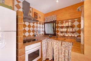 a kitchen with a stove and a refrigerator at Los Diegos in Navarrete del Río +23 photos