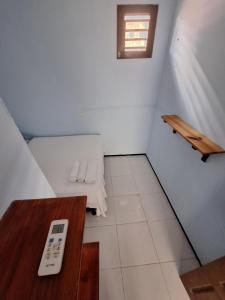 a small room with a remote control and a table at Pousada São João in Jericoacoara
