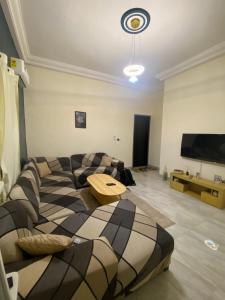 a living room with two couches and a television at Loft K&G in Cotonou