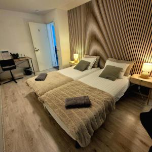 a bedroom with a large bed with two pillows on it at SO Easy Stay, Malmö in Malmö +16 photos