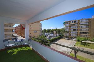 a balcony with a table and a view of a city at DELFINES Apartment in La Pineda