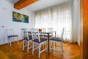 a dining room with a table and four chairs at DELFINES Apartment in La Pineda