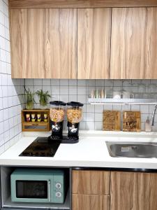a kitchen with two glass jars on a counter at 홍대 풀하우스!신축!무료주차!엘베 남들과다른 특별한공간 in Seoul +12 photos