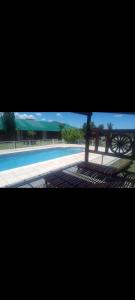 Una vista de una piscina con un banco al lado. en Nuevo Aire, en Santa Rosa del Conlara