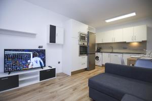 a living room with a couch and a kitchen at FORMENTOR Apartment in Salou +22 photos