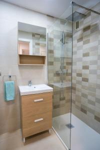 a bathroom with a sink and a shower at FORMENTOR Apartment in Salou