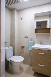 a bathroom with a toilet and a sink at FORMENTOR Apartment in Salou